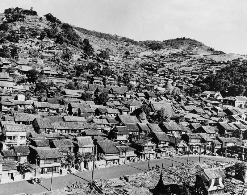 This photo, whose date is unknown, shows a residential district in Nagasaki. 
          The hills behind it apparently protected the district from severe damage by the atomic bombing.