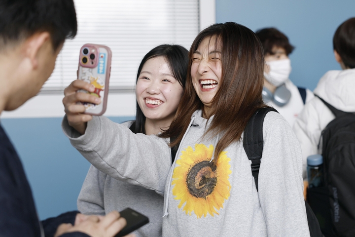 プラハの空港に到着し、笑顔で自撮りするフィギュアスケート女子の坂本花織(右)と中井亜美=23日(共同)